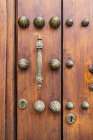 Centro District, Cordoba, Andalusia, Spain. Brass handle and decorations on old Spanish building. Art Print